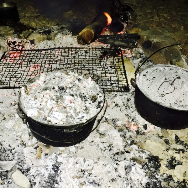 Camp ovens cook damper and billy tea cooked over the campfire in Outback Australia