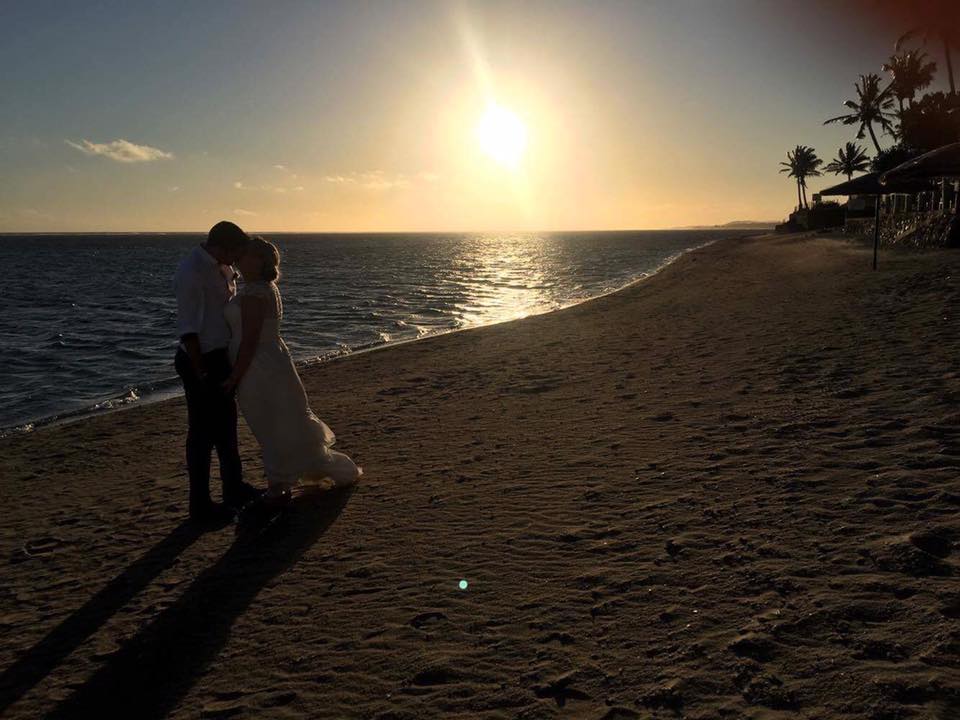 Sunset wedding photo on the beach at Outrigger Resort Fiji